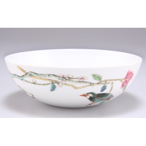 222 - A CHINESE FAMILLE ROSE BOWL, enamel painted with a bird perched on blossoming boughs, bears a six-ch... 