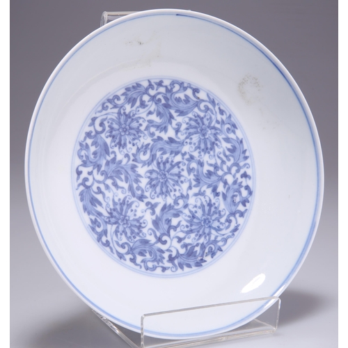 229 - A CHINESE BLUE AND WHITE SAUCER DISH, decorated with intricate florals scrolls, bears a six-characte... 