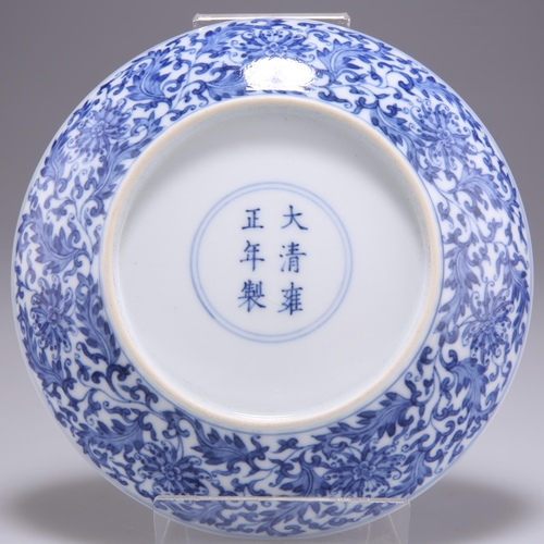 229 - A CHINESE BLUE AND WHITE SAUCER DISH, decorated with intricate florals scrolls, bears a six-characte... 