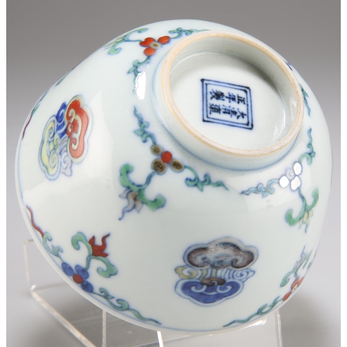 231 - A CHINESE DOUCAI BOWL, with deep rounded sides and standing on a short foot, painted and enamelled t... 