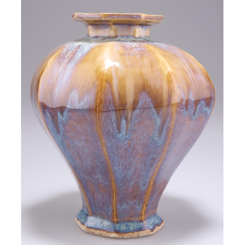 247 - A CHINESE VASE, of hexagonal-section baluster form, having a lustrous mottled glaze. 16.5cm high