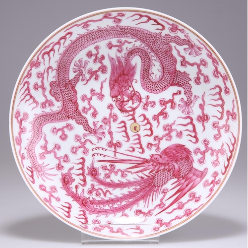 248 - A CHINESE PUCE DECORATED 'DRAGON AND PHOENIX' DISH, boldly decorated with a writhing five-clawed dra... 