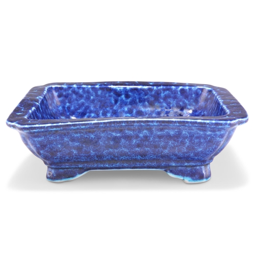 249 - A CHINESE BLUE-GLAZED DISH, rectangular with inverted corners, the thickly potted body with mottled ... 