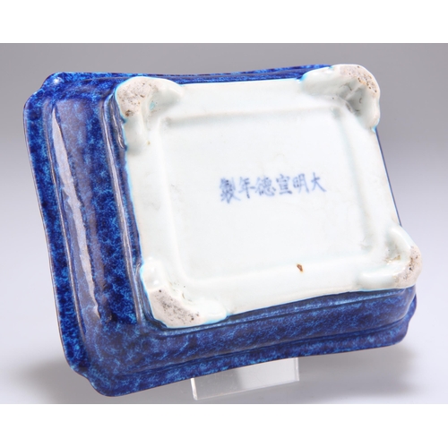 249 - A CHINESE BLUE-GLAZED DISH, rectangular with inverted corners, the thickly potted body with mottled ... 