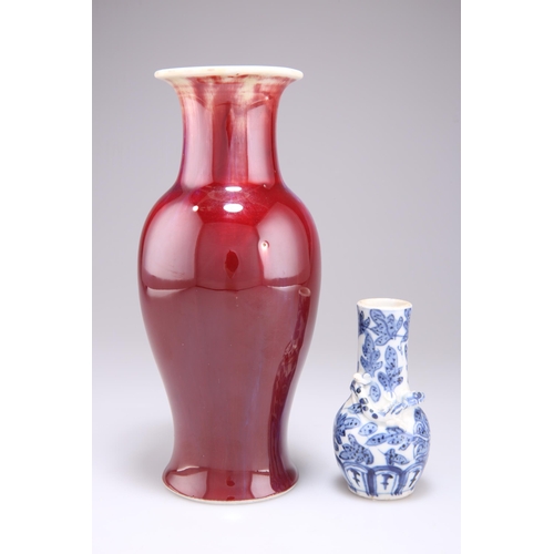 250 - A CHINESE FLAMBÉ GLAZE VASE, baluster form with a slender flared neck, glazed in streaked blue and o... 