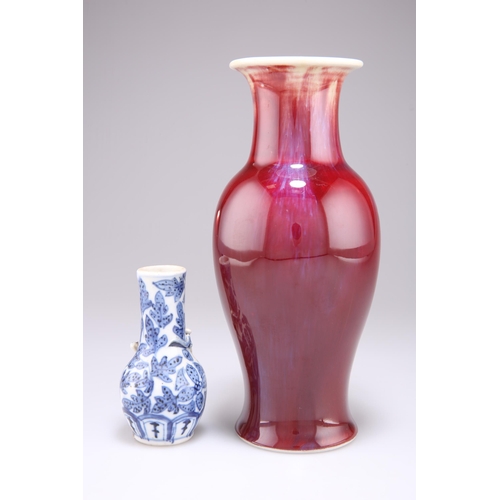 250 - A CHINESE FLAMBÉ GLAZE VASE, baluster form with a slender flared neck, glazed in streaked blue and o... 