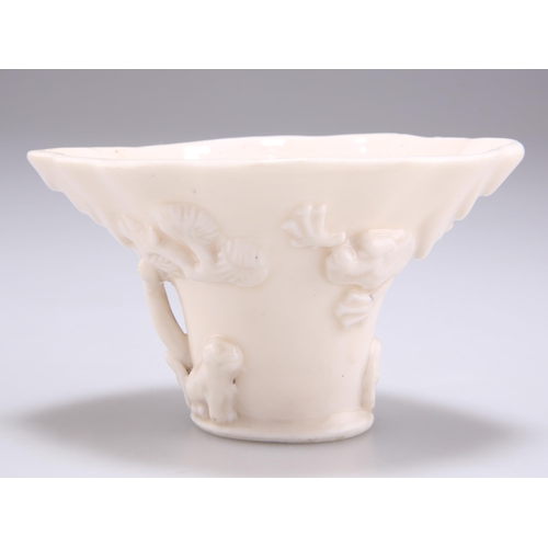 264 - A CHINESE BLANC DE CHINE LIBATION CUP, of a creamy colour. 10cm wide