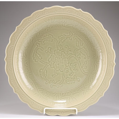 267 - A CHINESE LARGE CELADON DISH, the interior decorated with a large moulded lotus bloom, the everted r... 