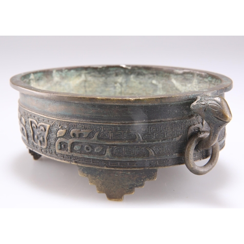 291 - A CHINESE BRONZE CENSER, QING DYNASTY, oval with ring handles and three stepped feet. 17.5cm wide ac... 