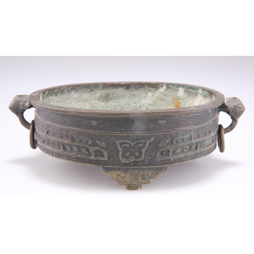 291 - A CHINESE BRONZE CENSER, QING DYNASTY, oval with ring handles and three stepped feet. 17.5cm wide ac... 