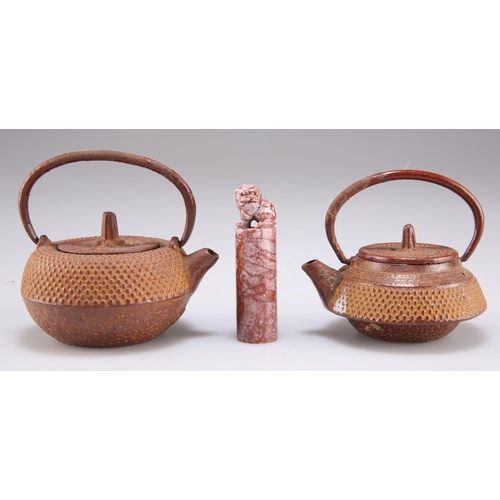 292 - TWO JAPANESE CAST IRON MINIATURE TEAPOTS; together with A CHINESE MARBLE SEAL, carved with Fu Dog fi... 