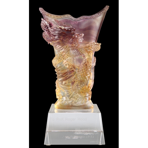 299 - A CHINESE COLOURED GLASS VASE, moulded in high relief with a dragon and phoenix, on a square plinth ... 