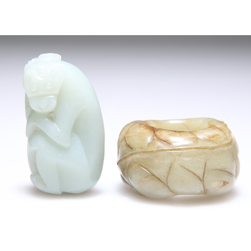 308 - A CARVED JADE THUMB RING, 2.5cm diameter; and A JADE CARVING OF A MONKEY, 5.2cm by 3cm. (2)