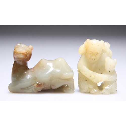 312 - A JADE CARVING OF AN ADULT AND CHILD WITH LOTUS, 5cm high; and A JADE CARVING OF A RECUMBENT CAMEL, ... 