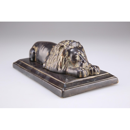 327 - A 19TH CENTURY BRONZE OF A RECUMBENT LION, on a rectangular bronze base. 18cm wide