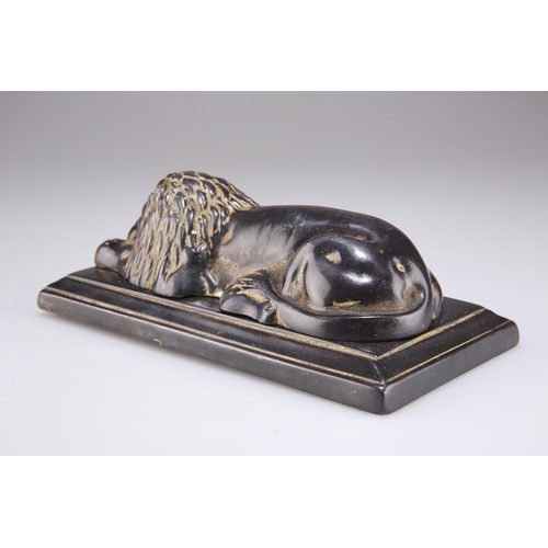 327 - A 19TH CENTURY BRONZE OF A RECUMBENT LION, on a rectangular bronze base. 18cm wide