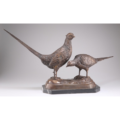 328 - A BRONZE MODEL OF A BRACE OF PHEASANTS, the cock and hen birds cast standing on a naturalistic undul... 