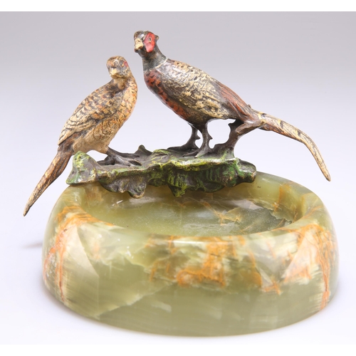 334A - AN ONYX AND COLD PAINTED BRONZE PHEASANT ASHTRAY, the circular ashtray surmounted by a brace of phea... 