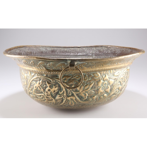 336 - A 17TH CENTURY BRASS WINE COOLER, deep bowl form and richly embossed with hounds, birds and mythical... 