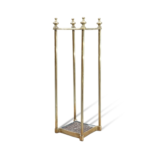 338 - AN EARLY 20TH CENTURY BRASS STICK STAND, square, with four sections. 62cm high