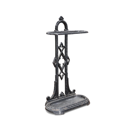 342 - A VICTORIAN SMALL CAST IRON STICK STAND, with arched back, painted black, registration lozenge to ba... 