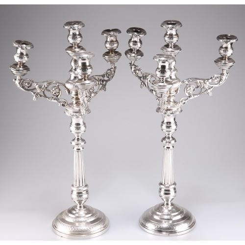 372 - A PAIR OF 19TH CENTURY CONTINENTAL SILVER FOUR-LIGHT CANDELABRA, each with scrolling foliate-form br... 