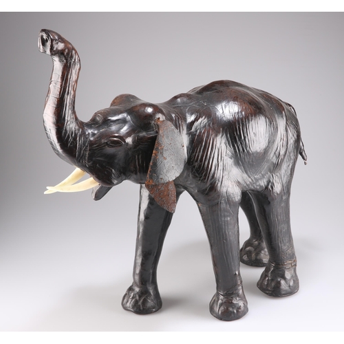 393 - AN EARLY 20TH CENTURY LEATHER MODEL OF AN ELEPHANT, in the manner of Liberty & Co, modelled with tru... 