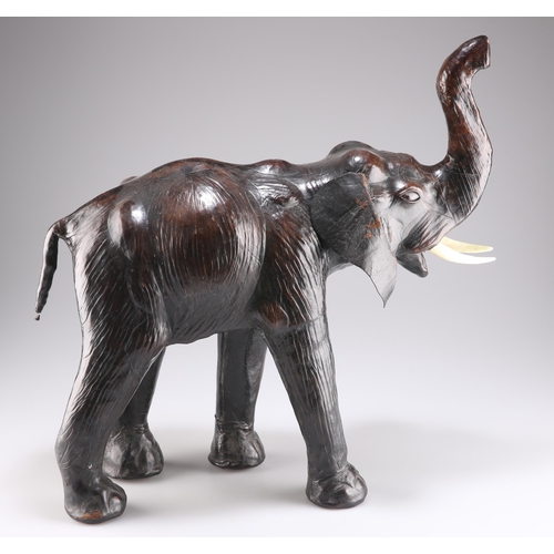 393 - AN EARLY 20TH CENTURY LEATHER MODEL OF AN ELEPHANT, in the manner of Liberty & Co, modelled with tru... 