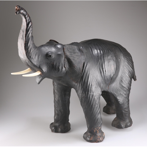 398 - A LARGE VINTAGE LEATHER MODEL OF AN ELEPHANT, modelled with trunk aloft. 64cm high