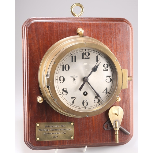 415 - A THIRD REICH KRIEGSMARINE BRASS BULKHEAD CLOCK, the silvered dial marked with eagle over M., the lo... 