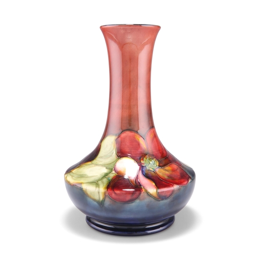 43 - A WALTER MOORCROFT FLAMBÉ POTTERY VASE, squat baluster form with a long flared neck, 'Clematis' patt... 