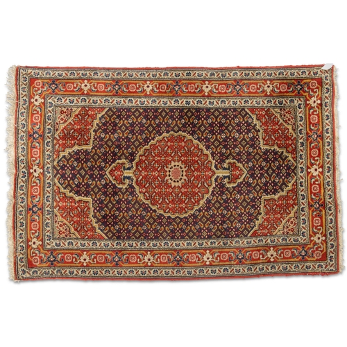 461 - AN AFGHAN HERAT RUG, hand-knotted, the dark blue field with red medallion and corners, the whole wit... 