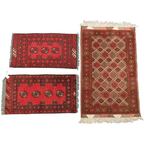 468 - FIVE VARIOUS SMALL RUGS, comprising A PERSIAN PRAYER RUG, hand-knotted, the deep raspberry ground wi... 