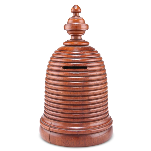 509 - A TREEN MONEY BOX, 19TH CENTURY, in the form of a beehive, with a coin aperture. 18cm high