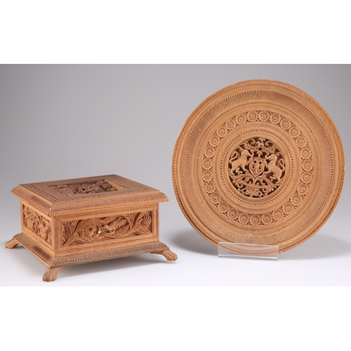 515 - AN INDIAN CARVED SANDALWOOD BOX, square form with a hinged lid and raised on four paw supports, carv... 