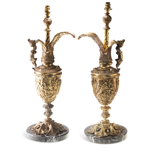 518 - A PAIR OF RENAISSANCE REVIVAL LARGE BRASS EWER LAMPS, 19TH CENTURY, each cast with figures and scrol... 