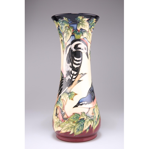 55 - A MOORCROFT POTTERY VASE, of trumpet form with a flared neck, tubelined and hand-painted with Philip... 