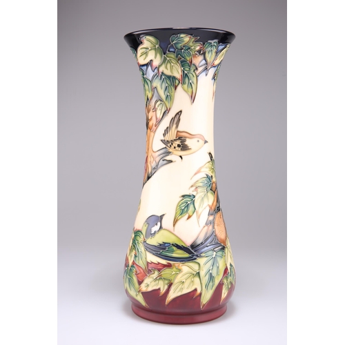 55 - A MOORCROFT POTTERY VASE, of trumpet form with a flared neck, tubelined and hand-painted with Philip... 