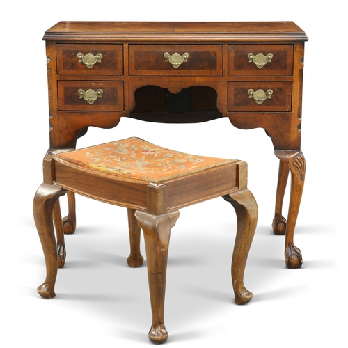 550 - A QUEEN ANNE STYLE WALNUT DRESSING TABLE, with half-veneered and crossbanded top above five drawers,... 