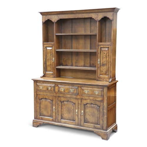 555 - A GEORGIAN STYLE POLLARDED OAK DRESSER, the boarded rack with a pair of cupboard doors and a pair of... 