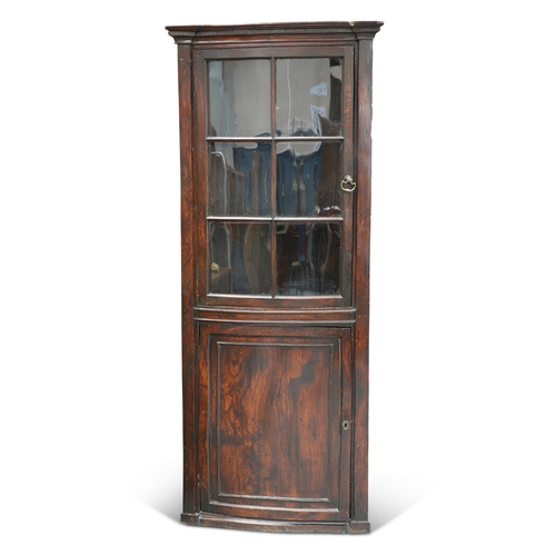 560 - A GEORGE III ELM BOW-FRONT FLOOR-STANDING CORNER CUPBOARD, with moulded cornice above a glazed door ... 