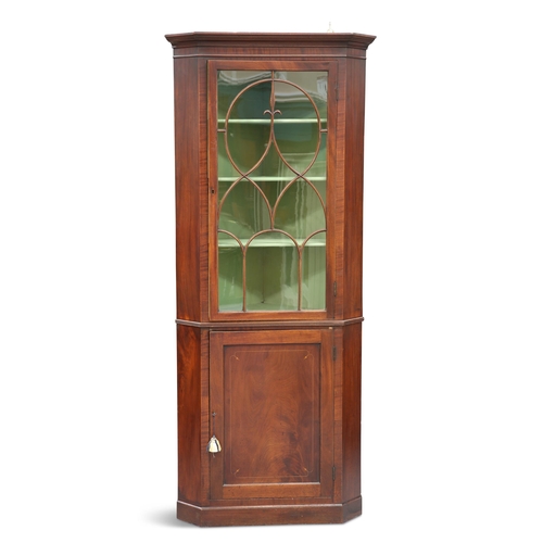 566 - A GEORGE III MAHOGANY FLOOR-STANDING CORNER CABINET, the glazed door with moulded bars forming an at... 