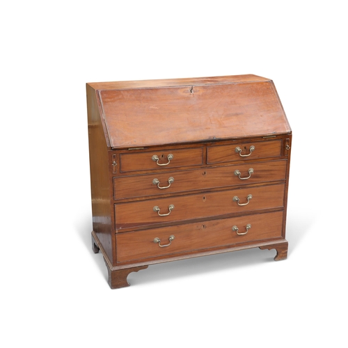 573 - A GEORGE III MAHOGANY SLANT-FRONT BUREAU, the slope opening to reveal a pair of drawers and pigeon h... 