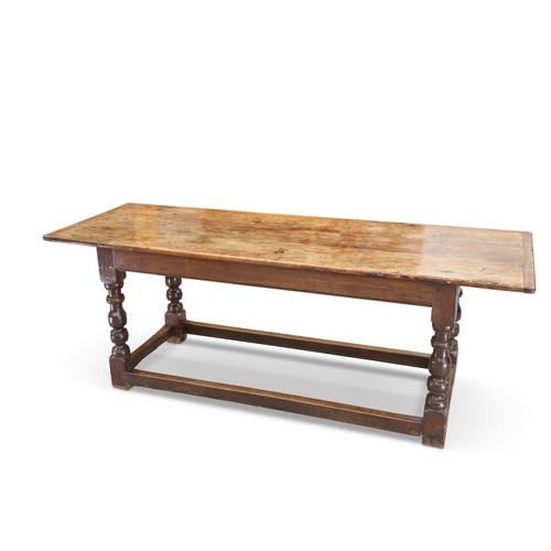 592 - AN 18TH CENTURY OAK REFECTORY TABLE, the rectangular cleated top raised on block and baluster legs j... 