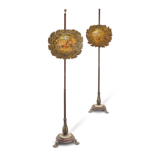 596 - A PAIR OF REGENCY BRASS-MOUNTED ROSEWOOD POLE SCREENS, each banner painted with figures within an oa... 