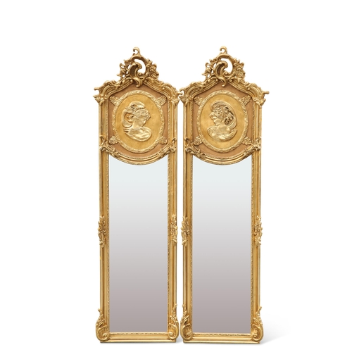 604 - A PAIR OF PERIOD STYLE GILT-COMPOSITION MIRRORS, each moulded with a maidens head below a pierced s... 