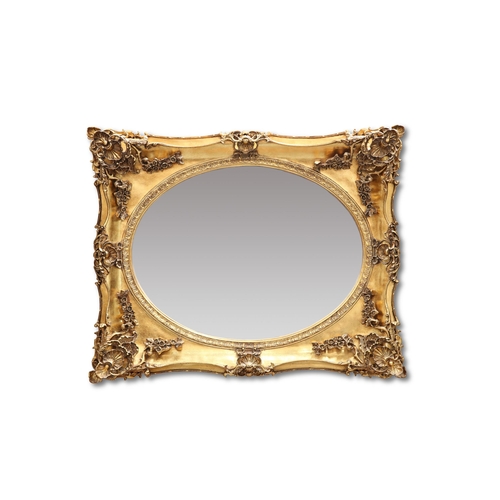 606 - A LARGE PERIOD STYLE GILT FRAMED MIRROR, the shaped rectangular frame moulded with foliage and shell... 