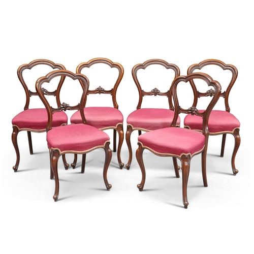 659 - A SET OF SIX VICTORIAN WALNUT BALLOON-BACK DINING CHAIRS, CIRCA 1870, with carved splats above stuff... 