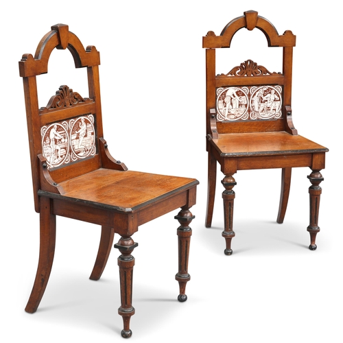 660 - A PAIR OF VICTORIAN OAK HALL CHAIRS WITH MINTON TILES, the back of each chair inset with a pair of J... 