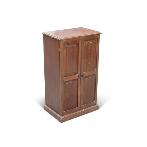 678 - AN EARLY 20TH CENTURY TEAK COLLECTORS CABINET, the pair of two-panel doors enclosing ten glass-topp... 